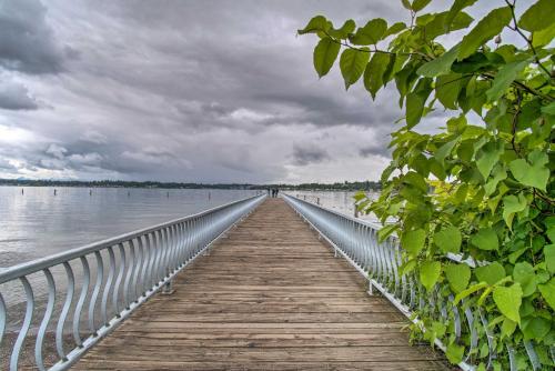 a wooden bridge over a body of water at Charming Updated Retreat Walk to Lake Stevens! in Lake Stevens
