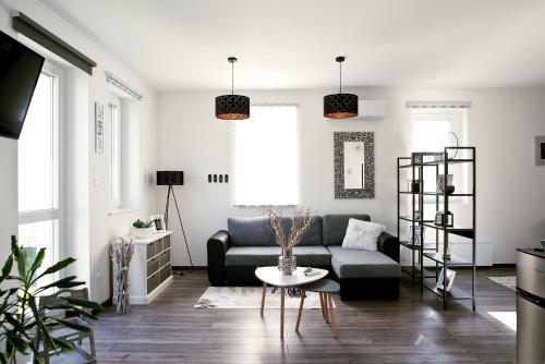 a living room with a couch and a table at A-765 Apartman in Szentgotthárd