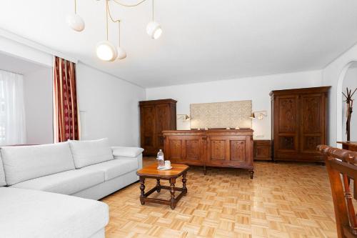 a living room with a couch and a table at Hotel-Restaurant-Café Krainer in Langenwang