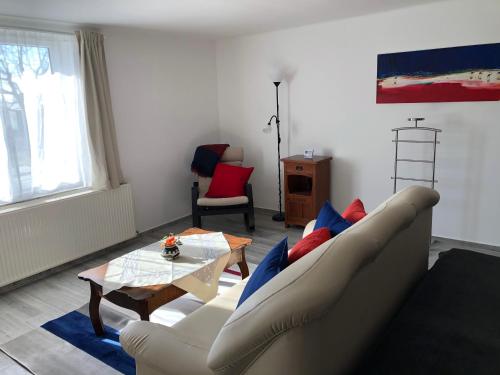 a living room with a couch and a table at Leander Apartman Balatonakali in Balatonakali