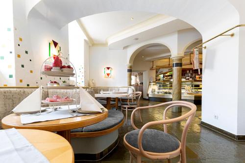 a restaurant with tables and chairs in a room at Hotel-Restaurant-Café Krainer in Langenwang