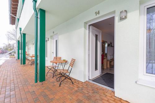 an open door to a patio with chairs and a table at Bergschlößchen in Jüterbog