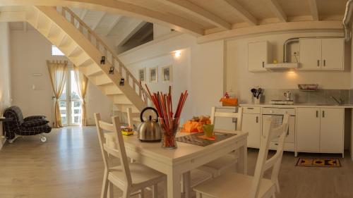 a kitchen with a table and chairs and a staircase at Agriturismo Orto dei Rolli in Moneglia