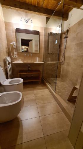 a bathroom with a shower and a toilet and a sink at Hotel Piazza Vecchia in Bergamo