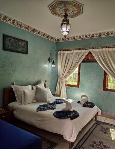 a bedroom with two beds with towels on them at Equi Palace & SPA Near Aeroport in Berrechid