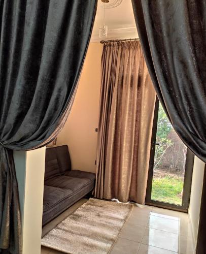 a living room with a couch and a window at Equi Palace & SPA Near Aeroport in Berrechid