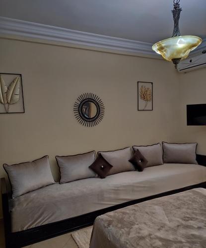 a living room with a couch with pillows on it at Equi Palace & SPA Near Aeroport in Berrechid