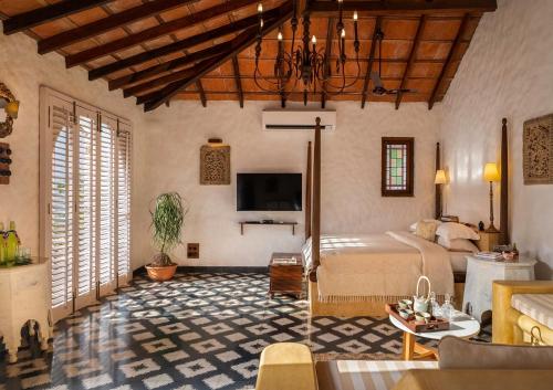 a bedroom with a bed and a tv in a room at Amrapali-House of Grace in Bambolim