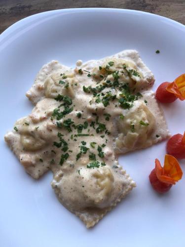 a white plate with a piece of food with sauce at Hotel Luna De Plata in Mahahual