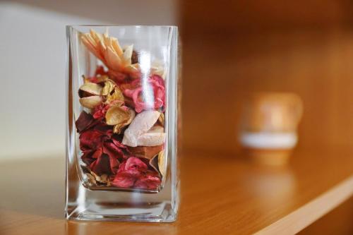 a glass jar filled with food on a wooden table at Apartments Suzana in Ždrelac