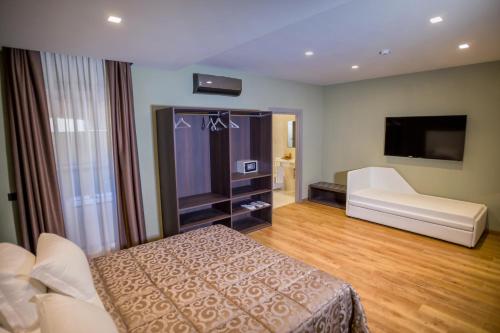 a hotel room with a bed and a flat screen tv at Hotel Europa Art Caserta in Caserta