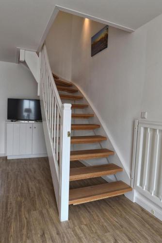 a staircase in a house with wooden steps at Stadtwohnung 8 in Wyk auf Föhr