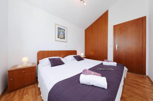 a bedroom with two beds with towels on them at Apartments Suzana in Ždrelac