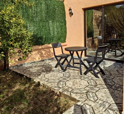 a patio with a table and chairs on a stone patio at Equi Palace & SPA Near Aeroport in Berrechid