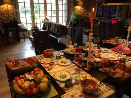 a table filled with different types of food at Manoir de La Rogerais & SPA in Beaussais sur Mer