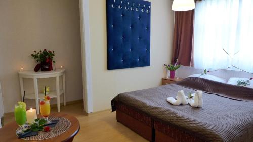 a bedroom with a bed and a table with candles at Wrzos & Belvedere in Kudowa-Zdrój