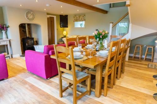 a dining room and living room with a table and chairs at The Patches in Shrewsbury