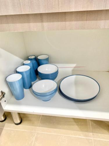 a group of blue and white bowls on a shelf at Hogar Cálido y Acogedor in León