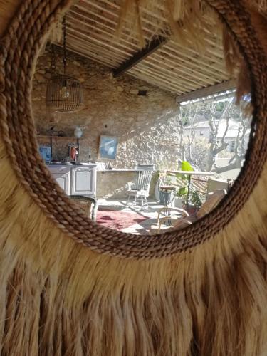 a view of a living room through a circular mirror at LA TERRASSE VIGNERONNE in Fitou