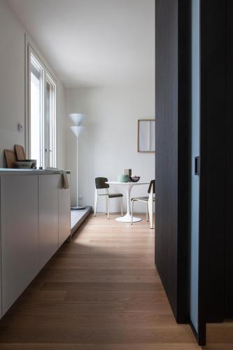 a kitchen and dining room with a table and chairs at BMORE Duomo - Luxury Apartments near Duomo in Milan