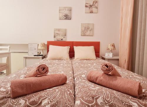 a bedroom with a bed with two pillows on it at Best Studio in Wrocław