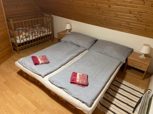 a bed with two pillows on it in a room at Chalupa ŠŠ in Vlachy