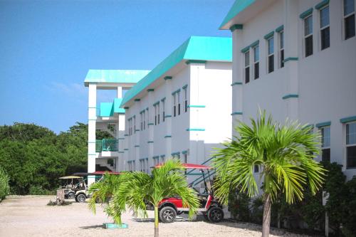 a hotel with palm trees in front of a building at Best Western Grand Baymen Gardens in San Pedro