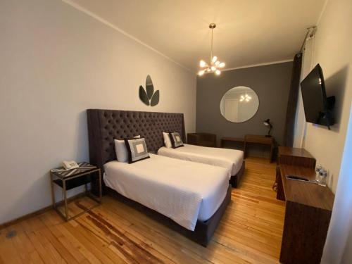 Posteľ alebo postele v izbe v ubytovaní Suites Alcazar