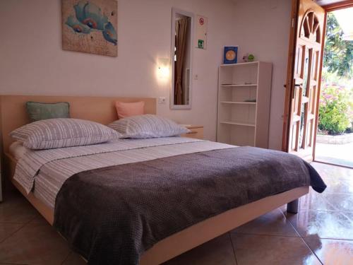 a bedroom with a large bed in a room at Apartmani Rita Studio in Novigrad Istria