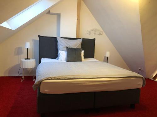 a bedroom with a large bed in the attic at K 11 Appartements in Offenburg