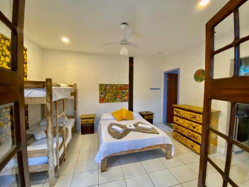 a bedroom with two bunk beds in a room at Vila Pequeá Pousada Ilhabela in Ilhabela