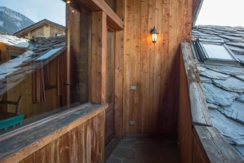 a wooden room with a window on the side of a building at Mont Blanc Apartments in Morgex