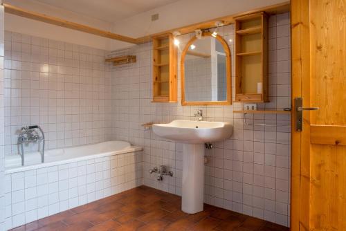 a bathroom with a sink and a bath tub at Mont Blanc Apartments in Morgex