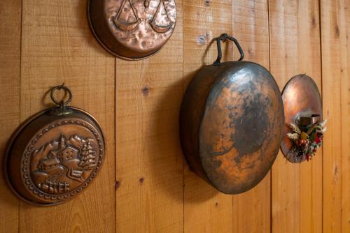 three indian shields hanging on a wooden wall at Mont Blanc Apartments in Morgex