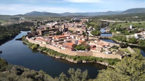 an aerial view of a town on a river at Puente viejo de Buitrago casa Fresno in Buitrago del Lozoya