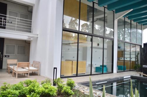 a view of the courtyard of a house with glass windows at Cozy Stays Cayala Apartments 4 in Guatemala