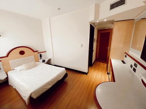 a bedroom with a white bed in a room at Best Western Hotel Solaf in Medolago