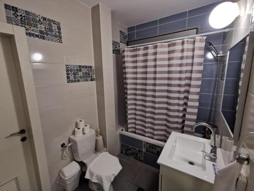 a bathroom with a toilet and a sink and a shower at Casa 2 Mitzpe Ramon in Mitzpe Ramon