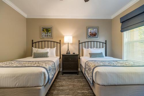 a bedroom with two beds and a window at Holiday Inn Club Vacations Williamsburg Resort in Williamsburg