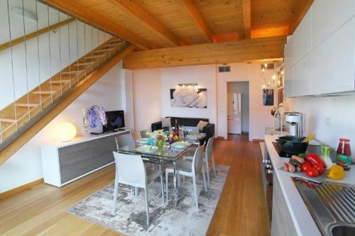 a kitchen and dining room with a table and chairs at Spectacular views and modern living on Lake Como in Bellano