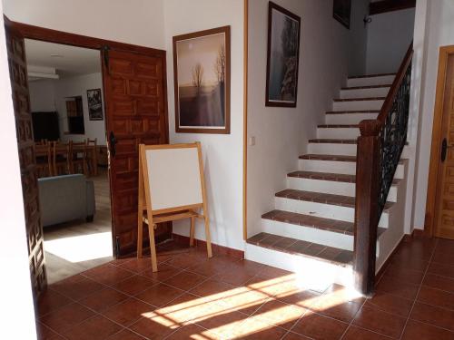 a staircase in a house with a painting on the wall at Albergue Fresno de Cantespino - La Tormenta in Fresno de Cantespino
