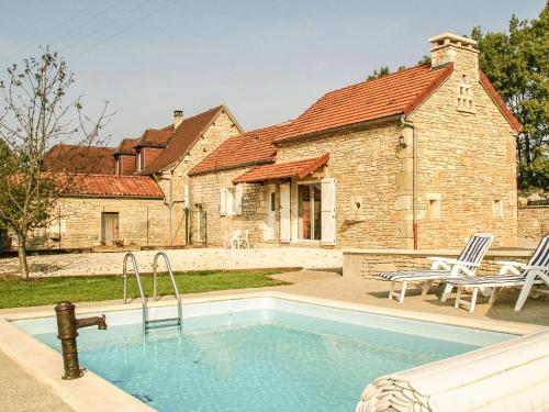a swimming pool in front of a house at Superb holiday home with pool in Cressensac