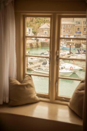 a window with a view of boats in a harbor at The Old Custom House in Padstow