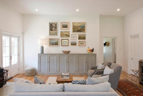 a living room with two chairs and a couch at Alkina Old Quarter Luxury Accommodation in Greenock