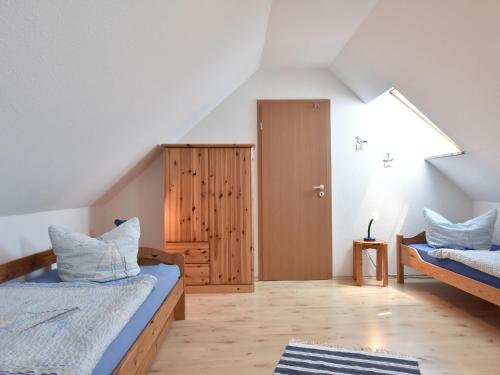 グラール・ミューリッツにあるSpacious apartment in Graal-Muritz Germany with Balconyの屋根裏部屋(ベッド2台、ドア付)