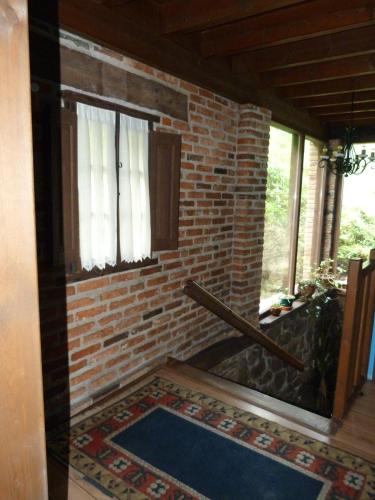 a room with a brick wall and a rug at Hotel Rural Los Texos in La Riera