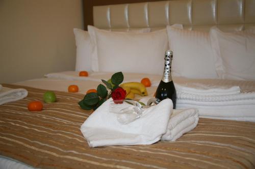 a bed with a bottle of champagne and towels at 7 Sky on Yevhena Konovaltsia in Kyiv