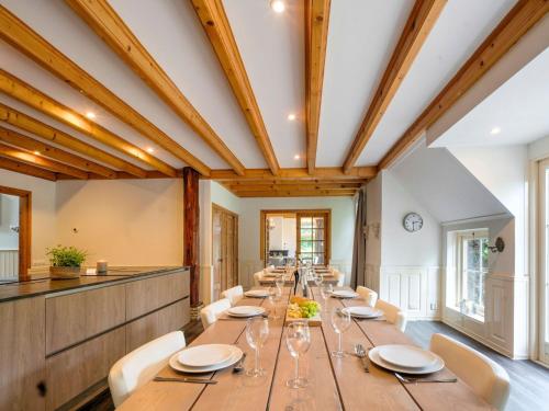 a large dining room with a long table and chairs at Gorgeous Farmhouse with Sauna in Noardburgum in Noordbergum