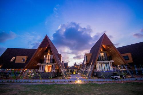 a building with three triangular roofs with a sky background at One of A Kind Resort @Trikora Beach - Bintan in Telukdalam