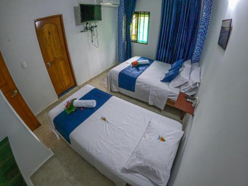 Una cama o camas en una habitación de Hotel Arena Azul